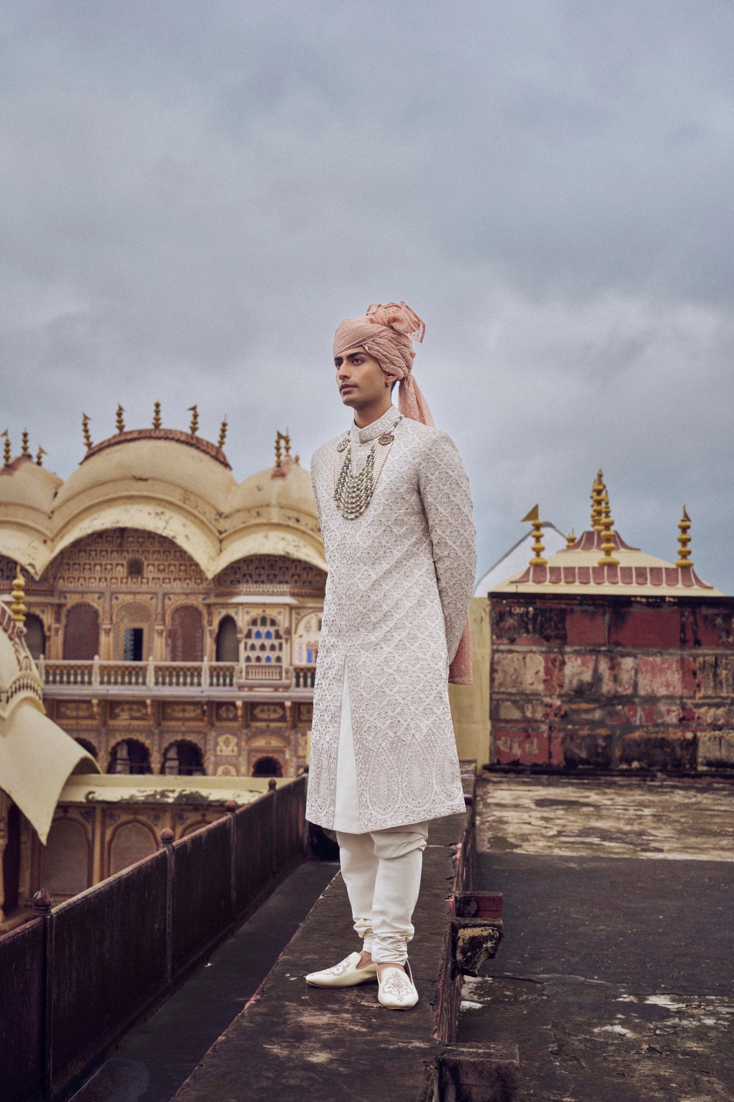 LIGHT BEIGE RAW SILK SHERWANI WITH KURTA AND CHURIDAR. IT COMES WITH AN OPTIONAL BELT, STOLE AND JUTIS